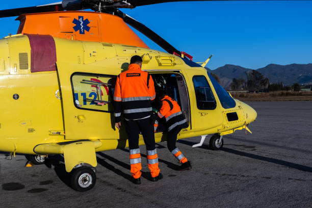 Paramedics outside the medical rescue helicopter Photo from behind the paramedics boarding the rescue helicopter to go out to an emergency call. aids walk stock pictures, royalty-free photos & images