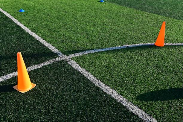 istock artificial green grass soccer field with orange training cones 2161598746