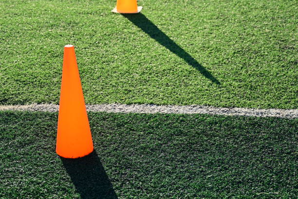 istock artificial green grass soccer field with orange training cones 2161600017