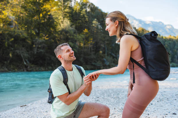 istock Man Proposes to Girlfriend While Hiking by River 2161600780