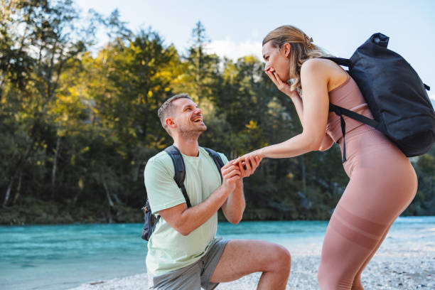 istock Man Proposing to Woman During Hike by River 2161600790