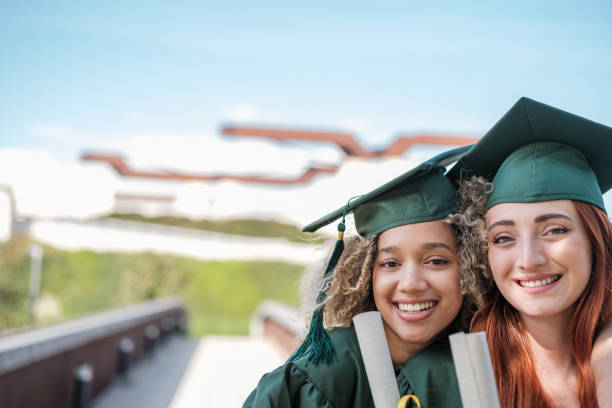 istock Two young women teaching their university degrees on graduation day. Concept: studies, education 2161604525