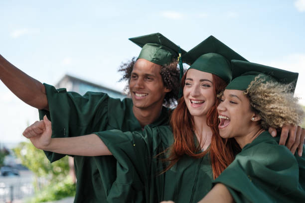 istock Group of graduate students taking a selfie outdoors and happy for having passed the university degree. Concept: studies, graduation, success 2161604565
