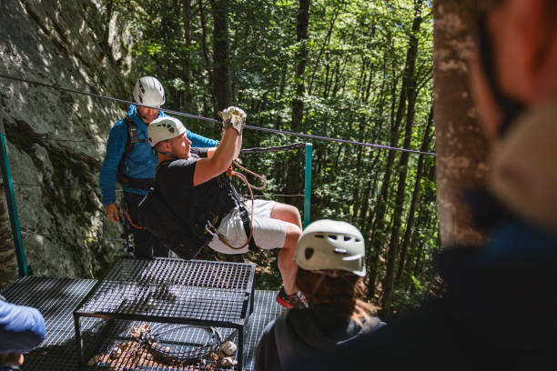 istock Adventure Enthusiasts Preparing for a Zipline Activity in Forest 2161605318