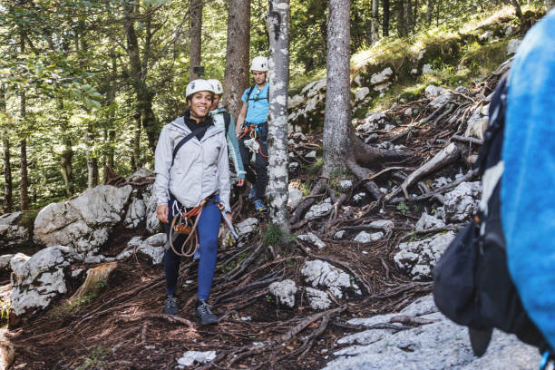 istock Adventurous Tourists Equipped for Ziplining in Forest 2161605367