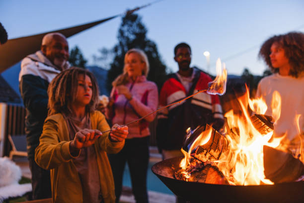 istock Multigenerational Mixed Race Family Enjoying a Campfire Outdoors at Dusk 2161607196