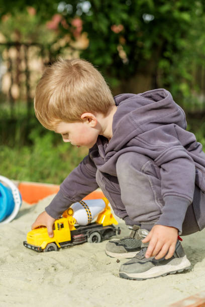 istock Boy Playing with Toy Truck in Sandbox 2161607281