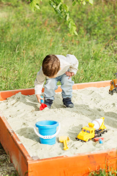 istock Child Playing with Toy Shovel in Sandbox 2161607664