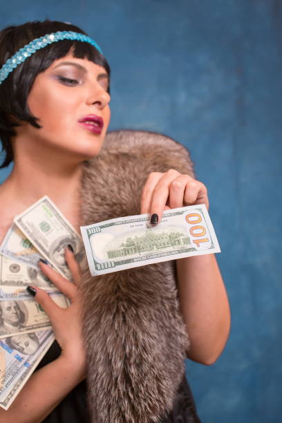 istock A woman holds 100 dollars 2161607788