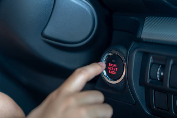 istock A young woman's hand is pressing the start button in a car 2161608455