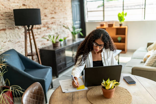 istock Young woman working using laptop at home 2161608690