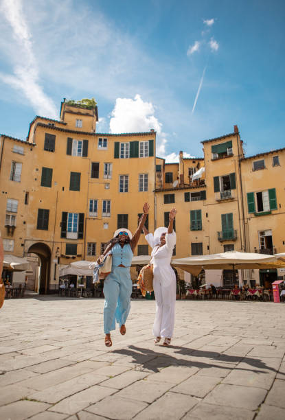 Two beautiful black female sisters enjoying a sightseeing day in Lucca, Italy together.