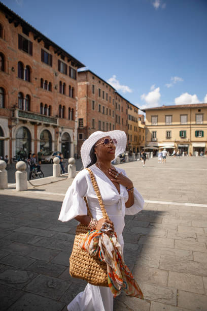 Beautiful black luxury female woman tourist enjoying a sightseeing day in Lucca, Italy