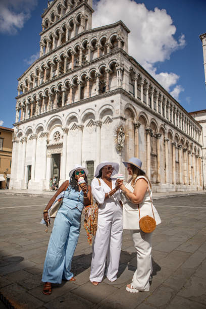 Lucca, Tuscany, Italy. Piazza San Michele, on left the Church of San Michele in Foro, in center of the square the staute of Francesco Burlamacchi. Around medioeval building and shops