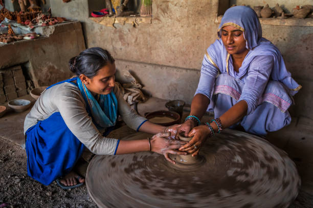 Indian potters working in a workshop, desert village in Rajasthan, India