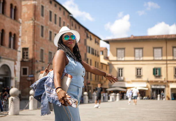 Beautiful black female woman tourist enjoying a sightseeing day in Lucca, Italy