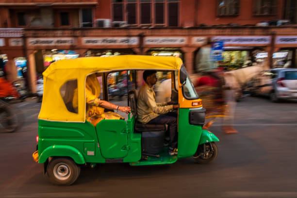 istock Indian man drives auto rickshaw (tuk-tuk), India 2161610810
