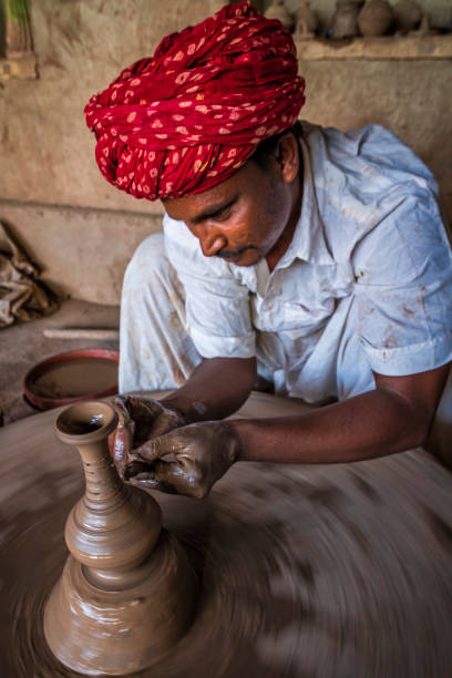 istock Indian potter working in his workshop, Rajasthan, India 2161612069