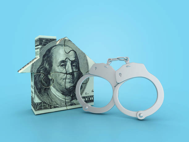 istock 3D Handcuffs with Dollar Puzzle House 2161616344