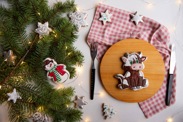 istock Festive Christmas gingerbread Cookies on Table with Pine Branches and Lights 2161616697