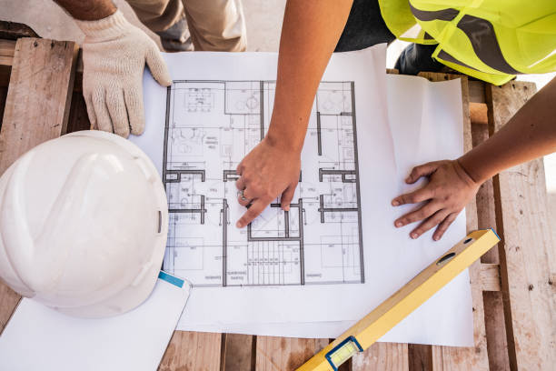 Close-up of a construction workers analyzing blueprint on construction site