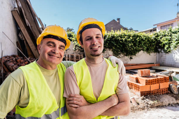 Portrait of construction workers embracing on a construction site