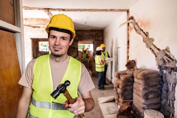 Portrait of a construction worker holding a hammer on a construction site