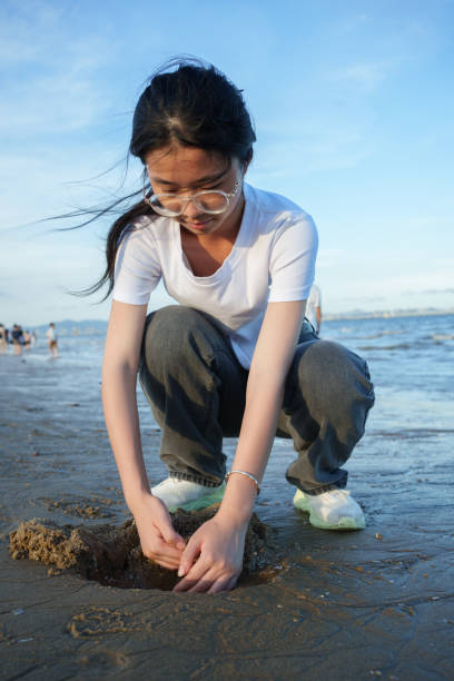 istock girl playing on the beach 2161618641