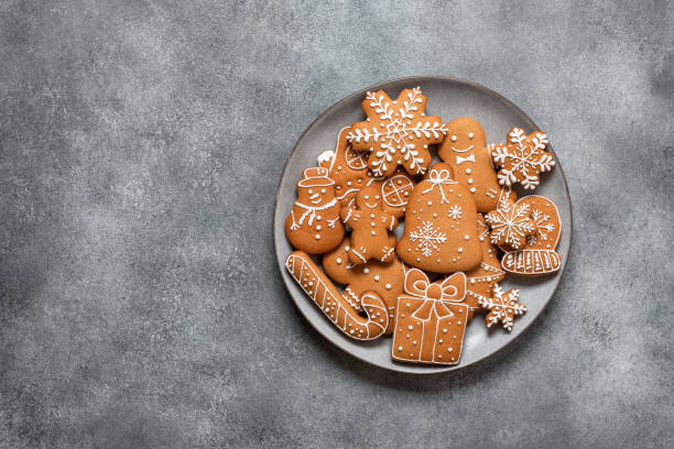 istock Assorted Christmas gingerbread cookies in a plate on a gray concrete background. Top view, flat lay, copy space. 2161621458