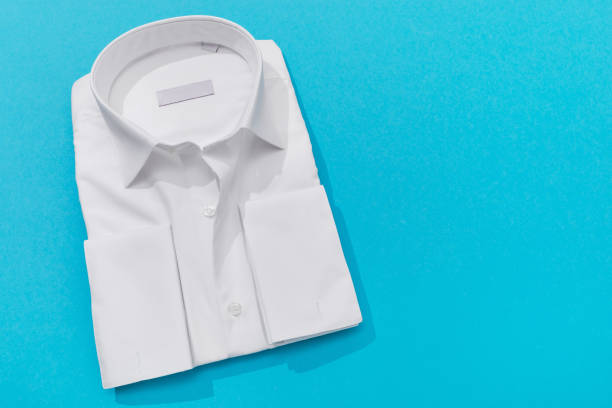 istock One classic white shirt with a long sleeve and cuff for cufflinks on a colored background with a copy of the space 2161623889