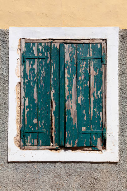 istock Old window shutters with green chipped paint 2161624049