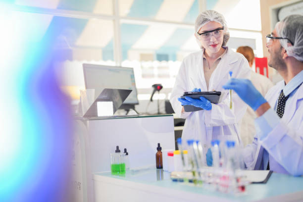 istock scientists perform experiments and record data. people arranges equipment with test tubes and chemicals for producing medicine and biochemistry. man hold tubes of chemical liquids and plant samples. 2161625242