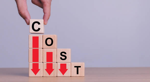 istock Cost reduction concept. Optimize manufacturing management. Optimization, Strategy, Economic cost savings. Hand puts wooden cube with words cost and green down arrows. cost icon on virtual screen. 2161625601