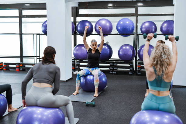 istock Pilates Dumbbell Workout Explained By Senior Female Athlete During Class 2161626056