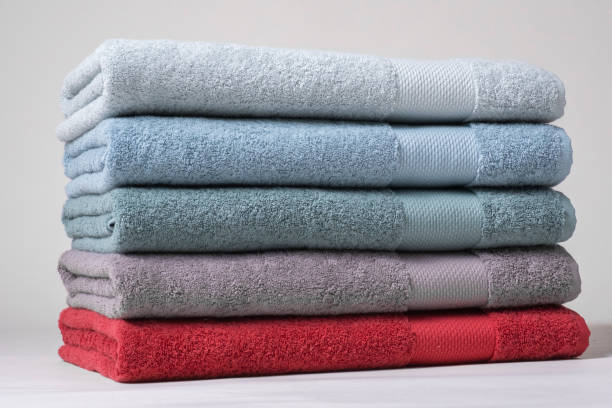 istock Stack of Towels in White, Light Blue, Dark Blue, Green, Grey, and Red on White Background 2161626300