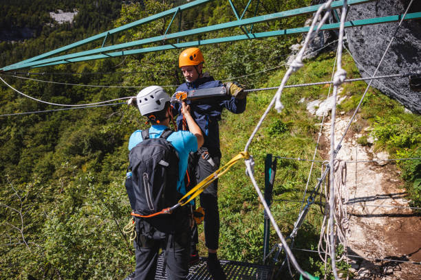 istock Zipline Instructor Assisting Tourist With Equipment 2161626301