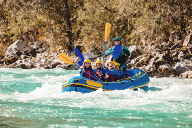istock Family Enjoying Whitewater Rafting Adventure with Guide 2161626356