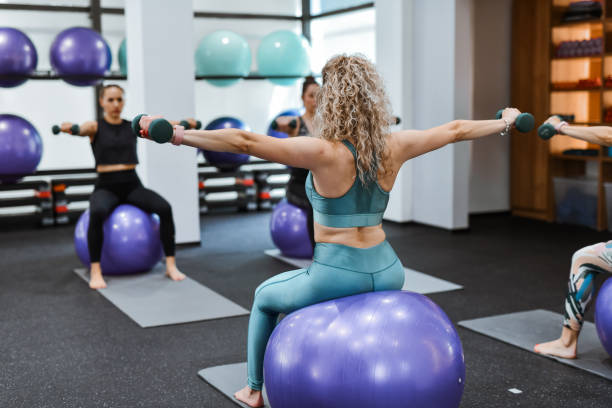 istock Athletic Females Working On Shoulder Muscles During Pilates Class 2161627113