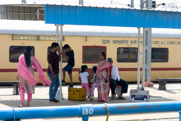This image is from mayiladuthurai City, State Tamilnadu Country India, on 20th June 2024. In the golden glow of the railway station, a close-knit family shares laughter