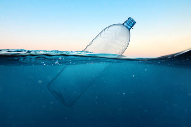 istock Empty plastic bottle floats in water. Ocean pollution concept. Global warming. View under water 2161629563