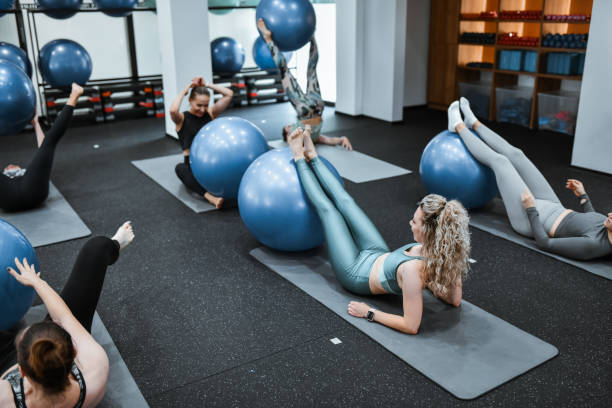 istock Athletic Females Targeting Upper Abs With Pilates Ball 2161630459