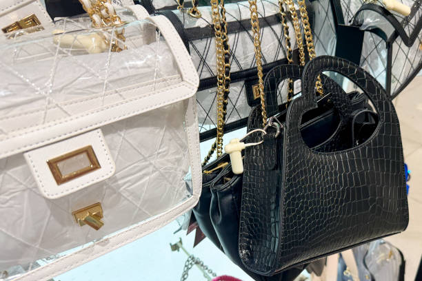 istock stylish handbags featuring various designs, including a white quilted bag and a black croc-embossed bag, with gold chain straps 2161631127