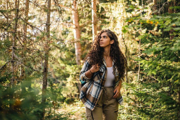 istock Thoughtful hiker gazing ahead in sunlit forest 2161634428