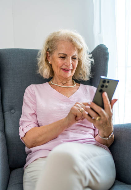 istock Senior woman using phone at home 2161635829