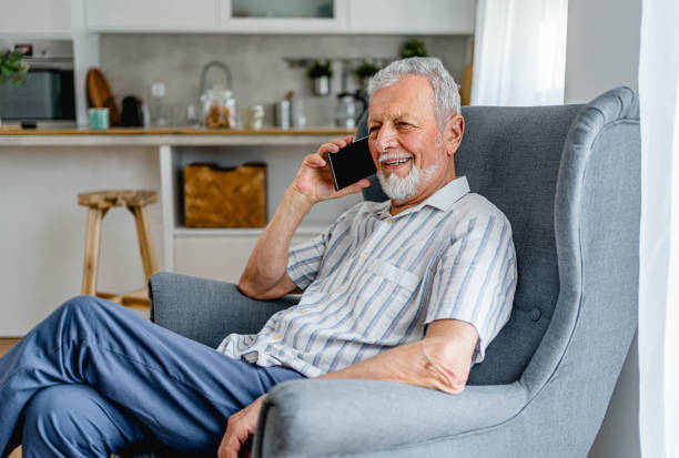 istock Senior man having a phone call at home 2161636359