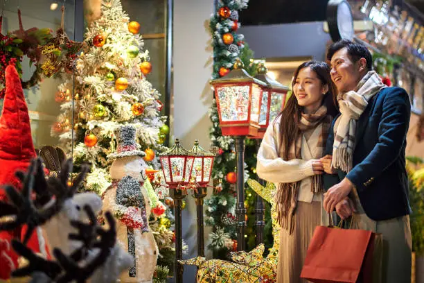 Asia Couple Choosing Christmas Ornament at Christmas Market Asia Couple Choosing Christmas Ornament at Christmas Market