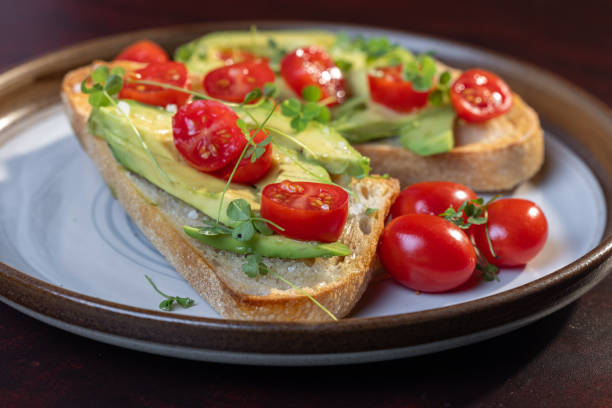 istock avocado toast topped with tomato and sprouts 2161639685
