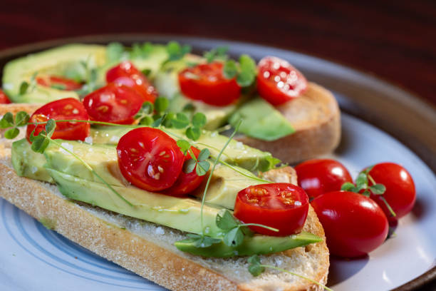istock avocado toast topped with tomato and sprouts 2161639763