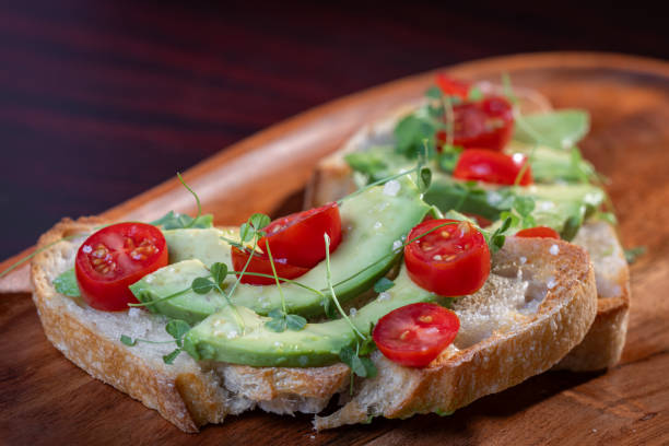 istock avocado toast topped with tomato and sprouts 2161640673