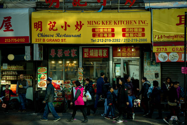 February 5, 2019: Street in Chinatown in New York City full of people walking on sidewalk